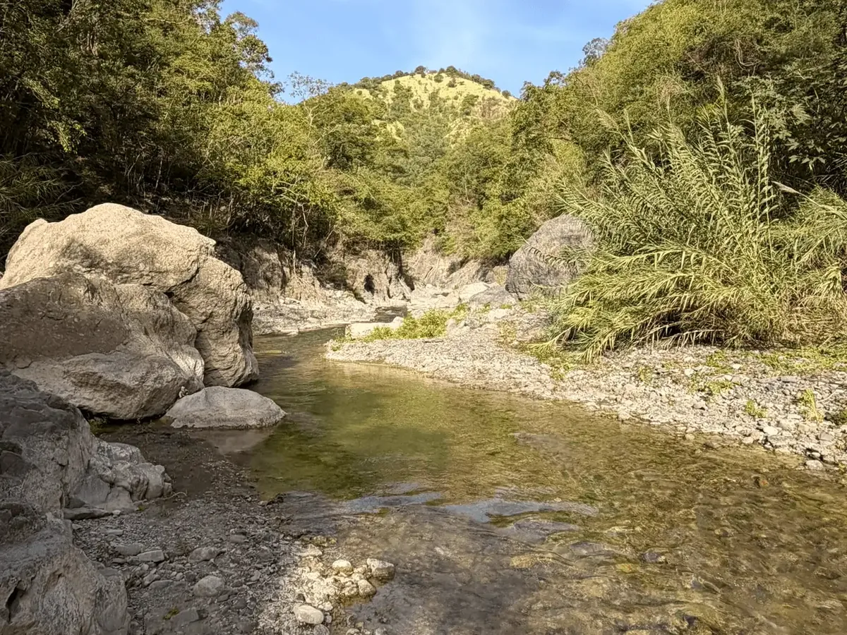 Clear river pool between boulders on the Heineken River hike in St. Thomas, Jamaica