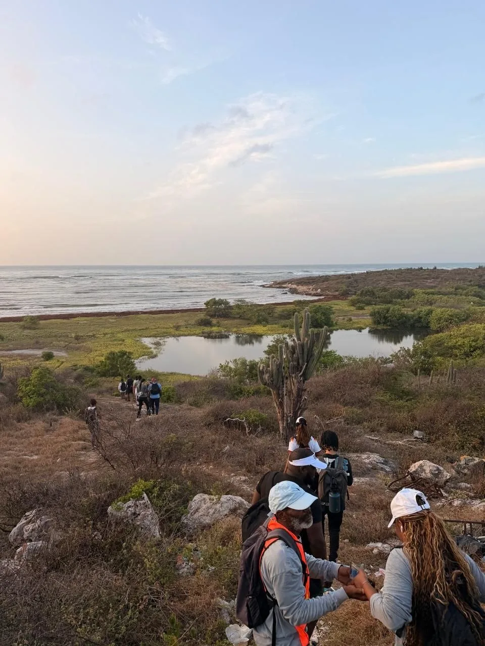 Lifestyle Hikers crossing the Hellshire wetlands, mangrove forest, lagoon, and coastline in the distance