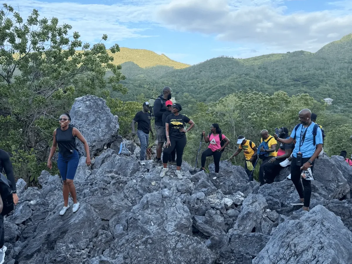 Lifestyle Hikers crossing the jagged limestone rocks at Judgement Cliff, St. Thomas